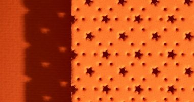 top-view-microperforated-sheet-with-orange-background_23-2150260321